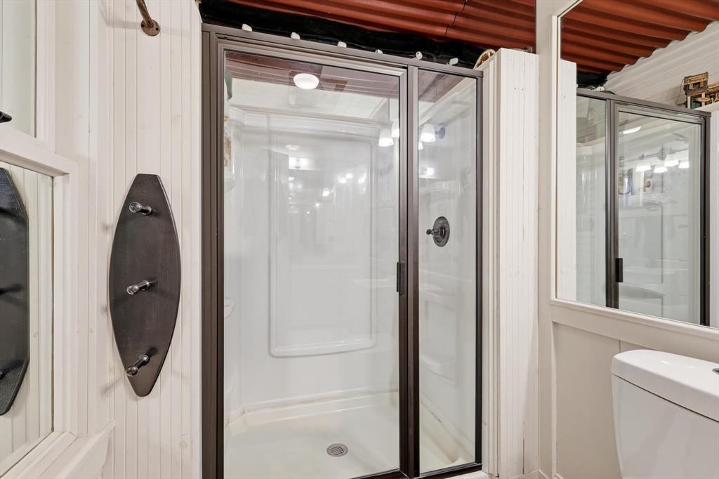 4513 Chapel Road Graham, TX 76450 - Photo 20 of 38 a bathroom with a glass shower door