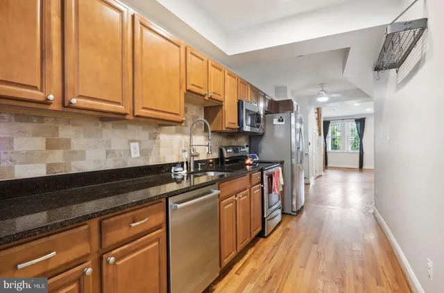 a kitchen with stainless steel appliances granite countertop a sink and cabinets