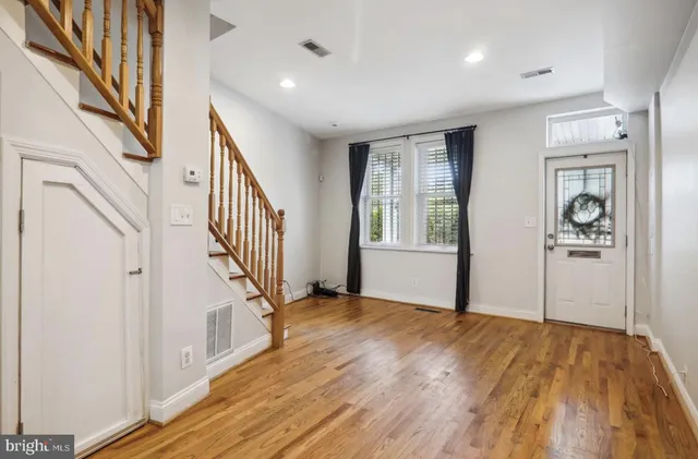 a view of an entryway with wooden floor and stairs
