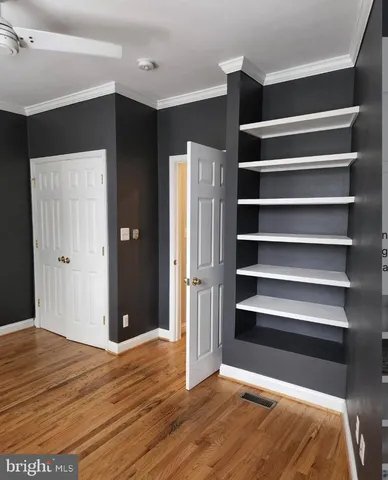 a view of bedroom with wooden floor