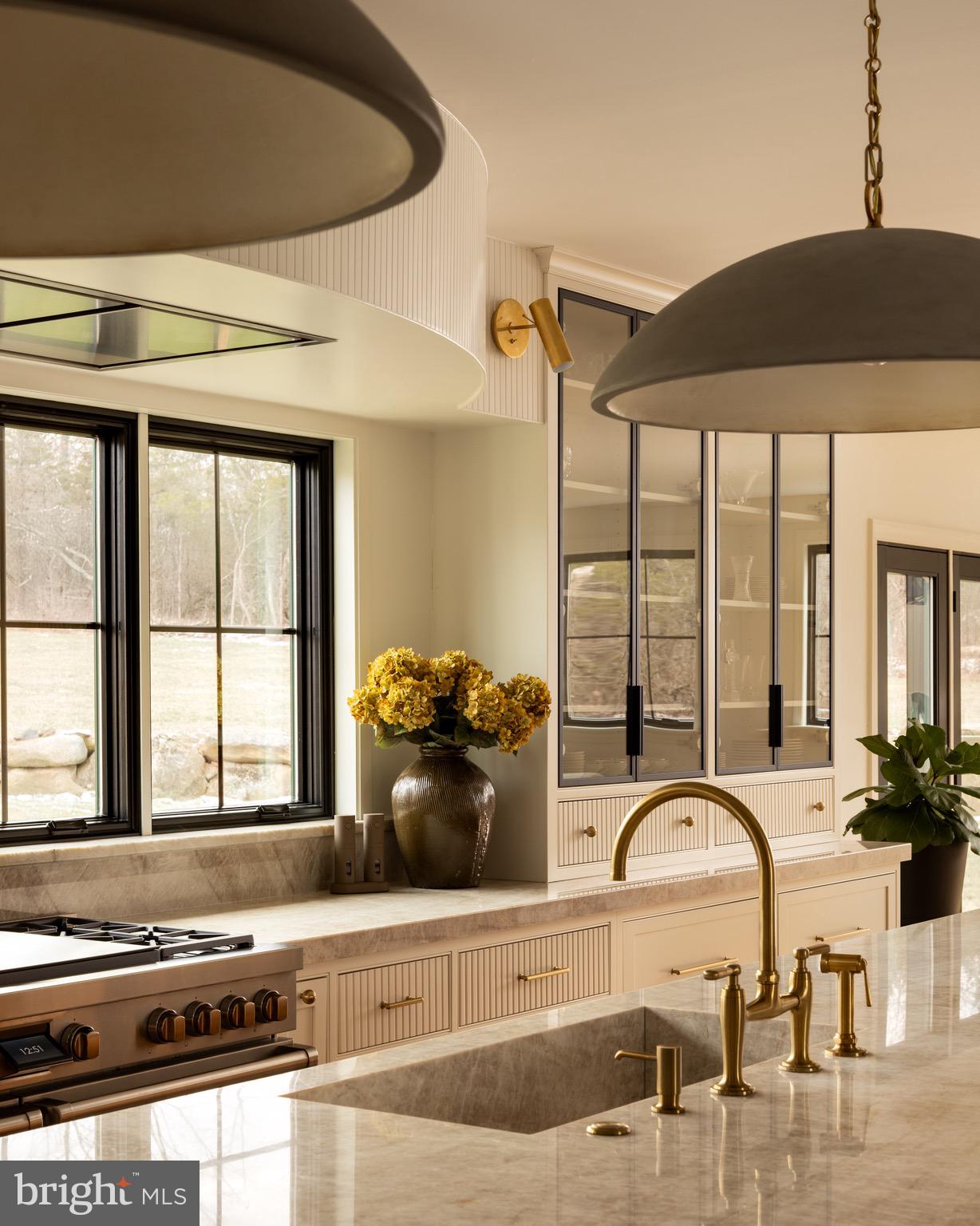 1400 Fairhill Road Sellersville, PA 18960 - Photo 10 of 41 a kitchen with a stove a sink and a dining table with garden