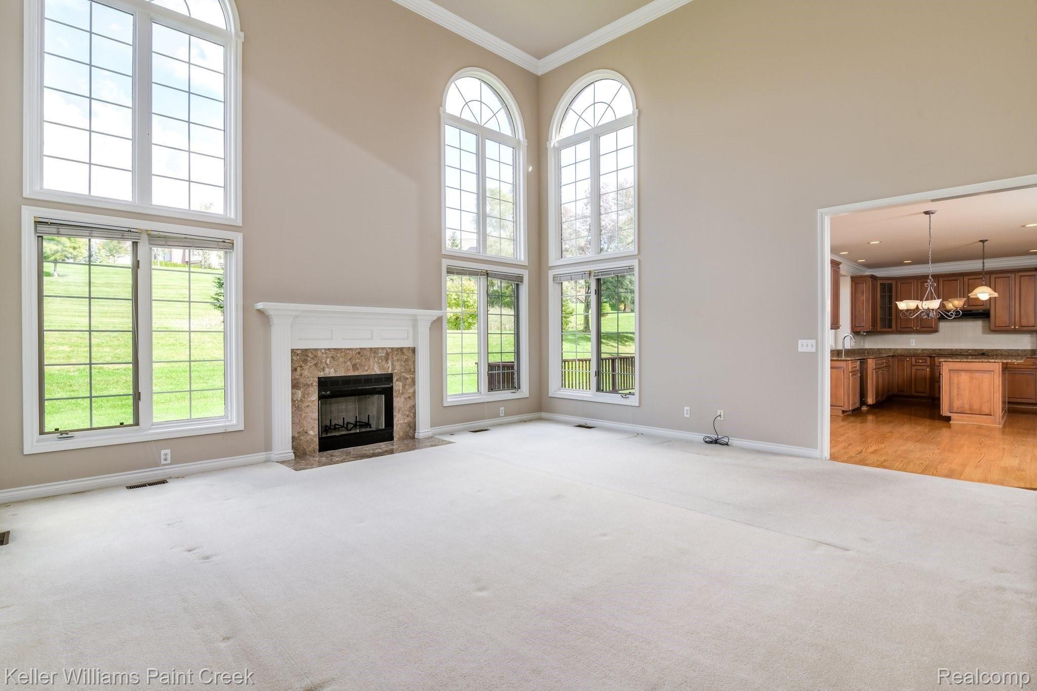 1163 Autumnview Drive Rochester, MI 48307 - Photo 7 of 34 The great room offers lots of natural light, tons of furniture options, and direct access to the kitchen and wet bar.