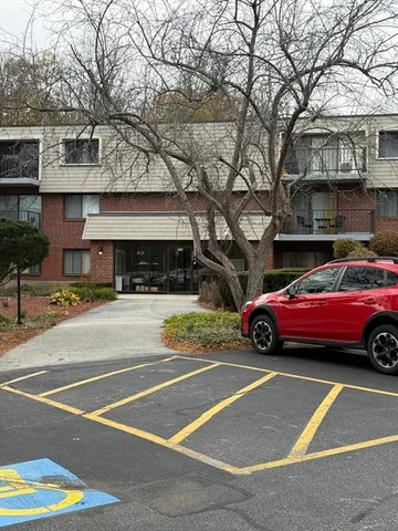 a view of a cars parked on the side of a street