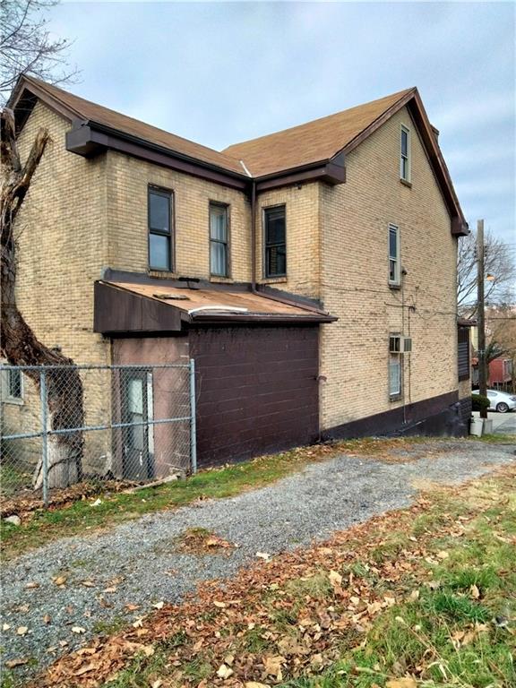 522 Freeland Street Pittsburgh, PA 15210 - Photo 2 of 19 a front view of a house with a yard