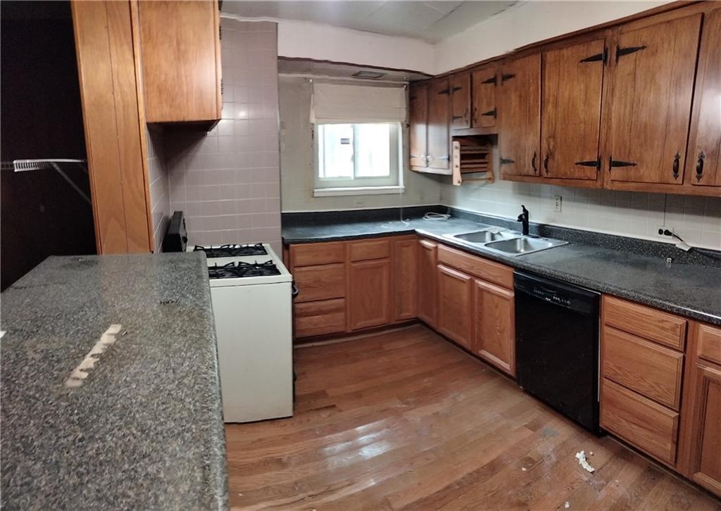522 Freeland Street Pittsburgh, PA 15210 - Photo 5 of 19 a kitchen with stainless steel appliances granite countertop a stove a sink and a microwave