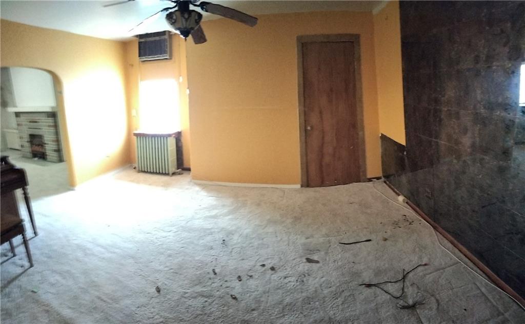 522 Freeland Street Pittsburgh, PA 15210 - Photo 9 of 19 a view of a livingroom with wooden floor and a bathroom