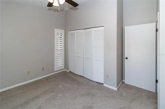 an aerial view of a house with large trees and flower plants