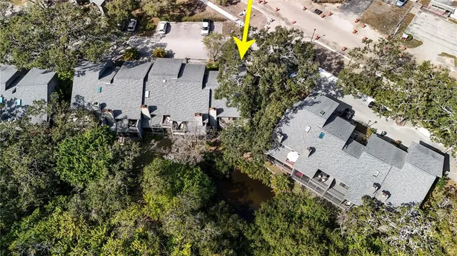 an aerial view of a house with a yard and tree s