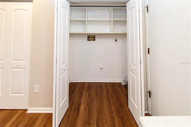 a view of a bedroom with wooden floor and closet