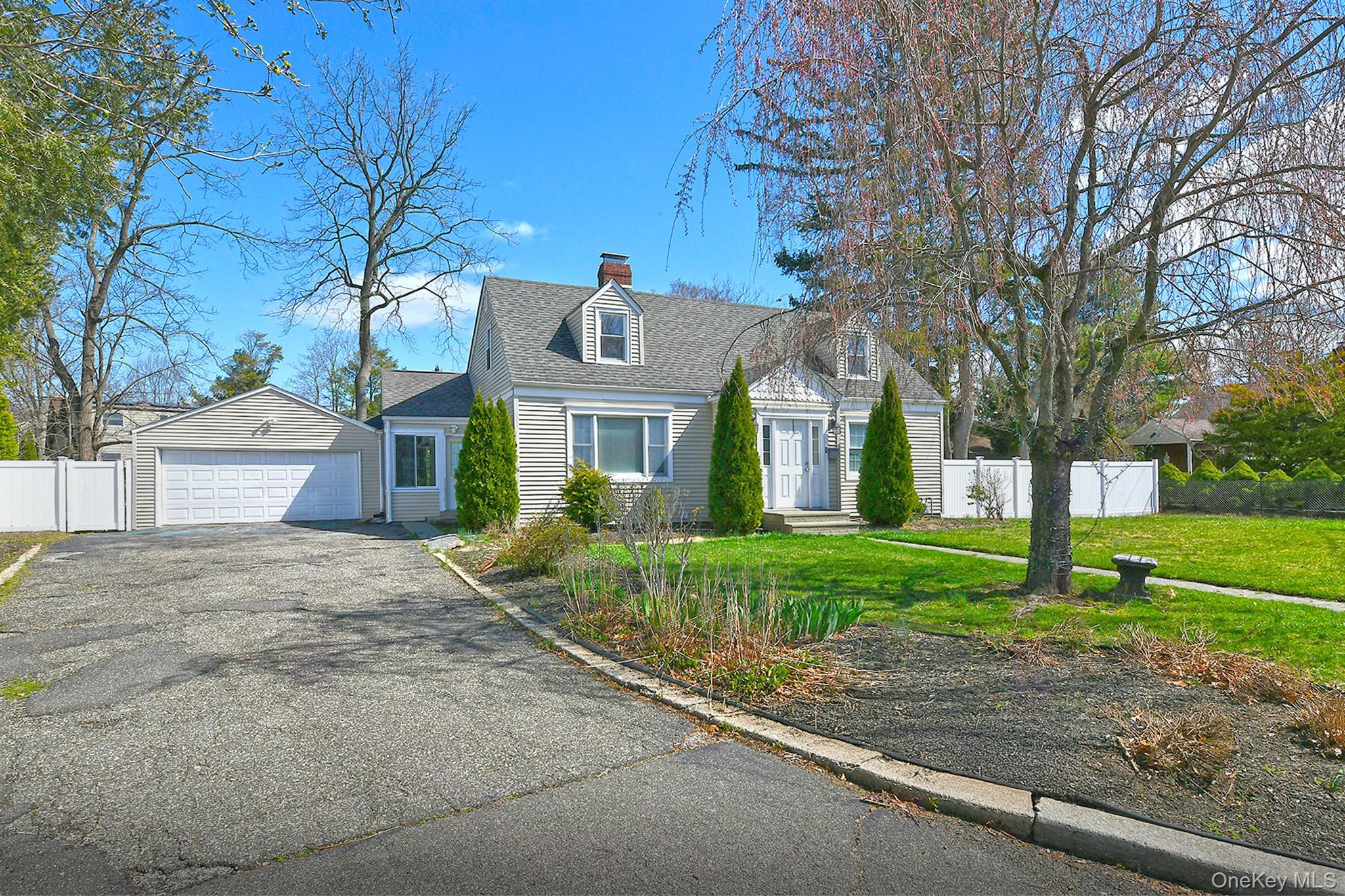 86 Horton Place Syosset, NY 11791 - Photo 1 of 22 a front view of a house with garden