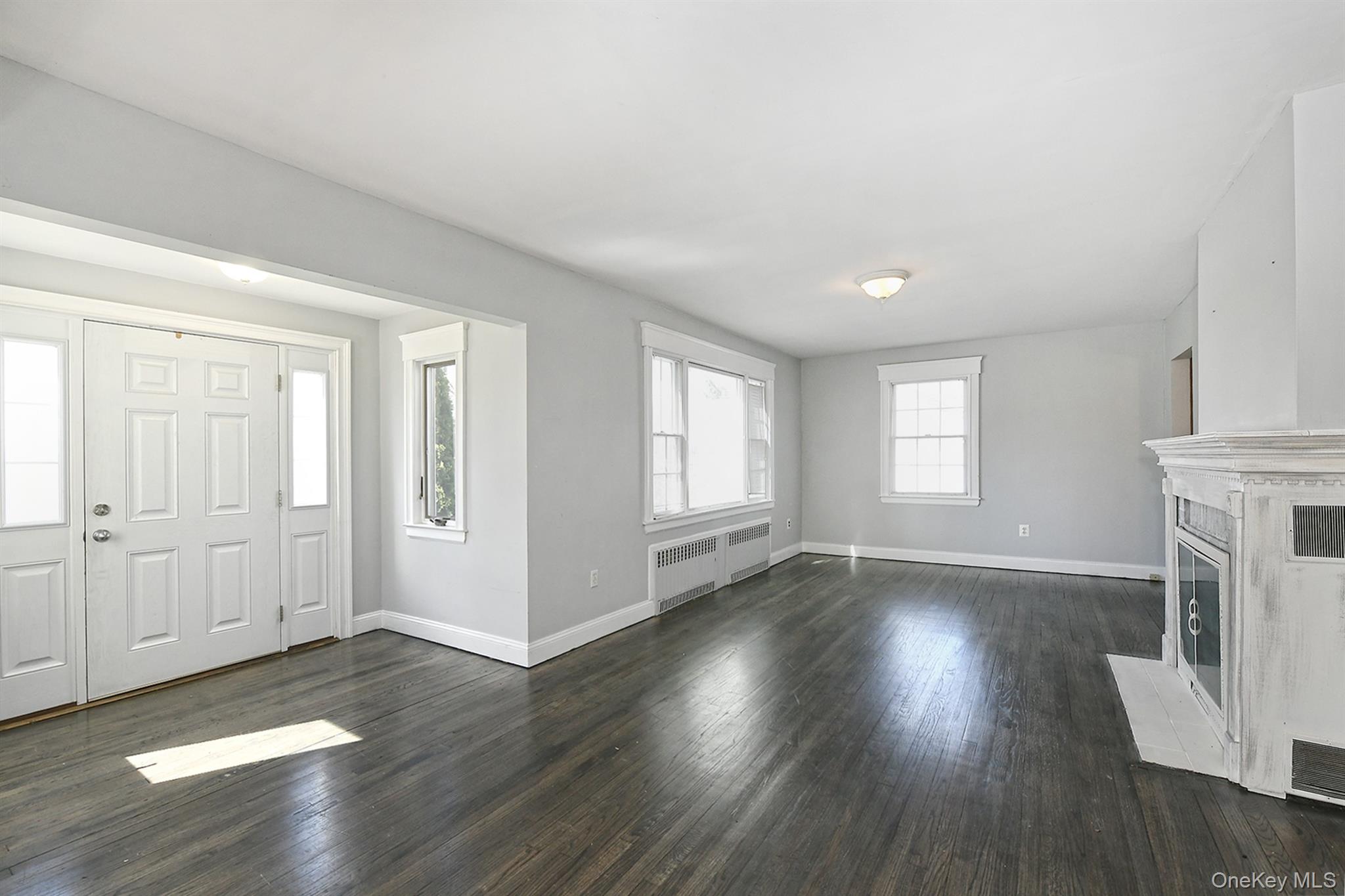 86 Horton Place Syosset, NY 11791 - Photo 3 of 22 an empty room with wooden floor and windows