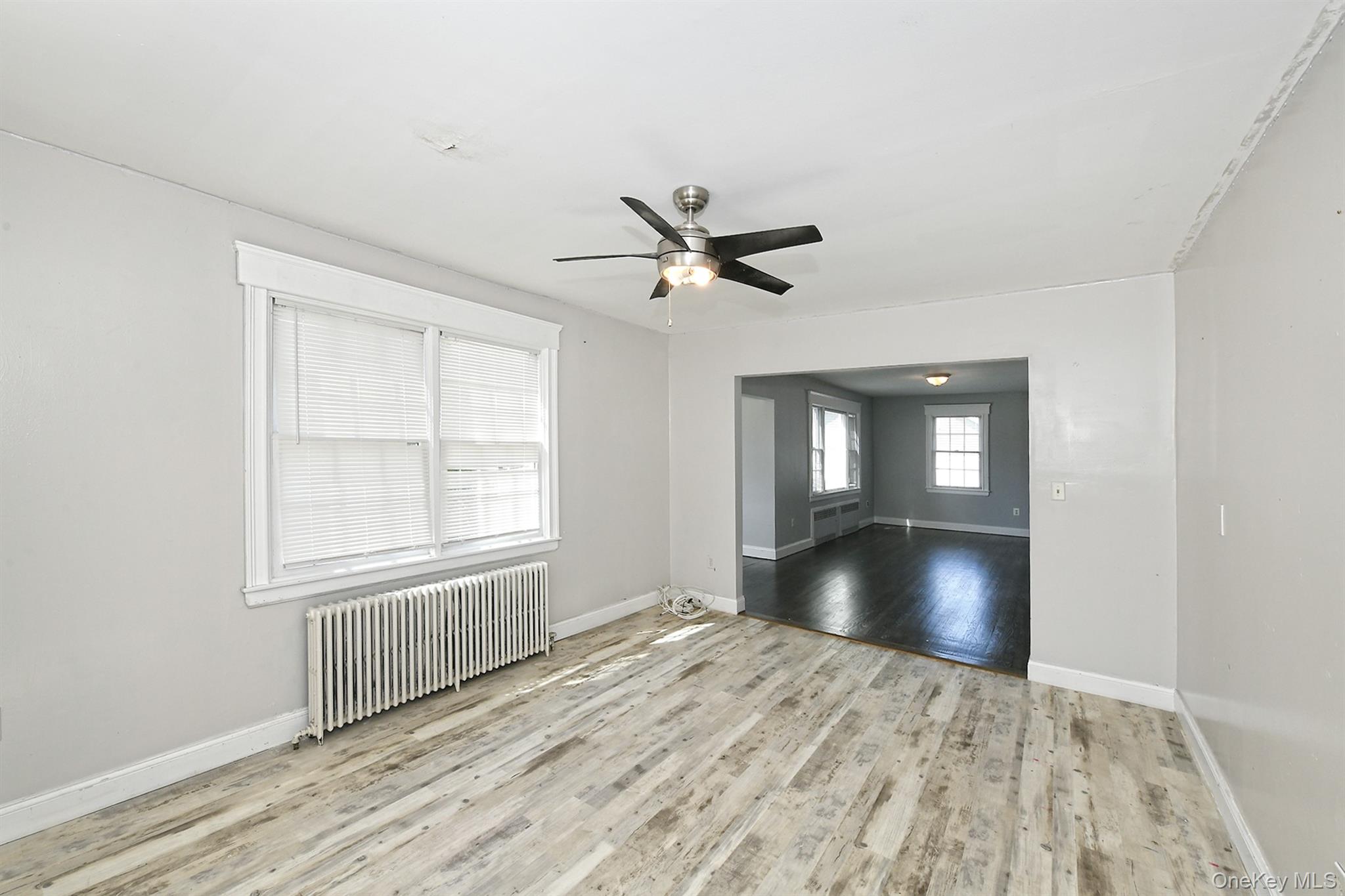 86 Horton Place Syosset, NY 11791 - Photo 5 of 22 a view of an empty room with a window and wooden floor