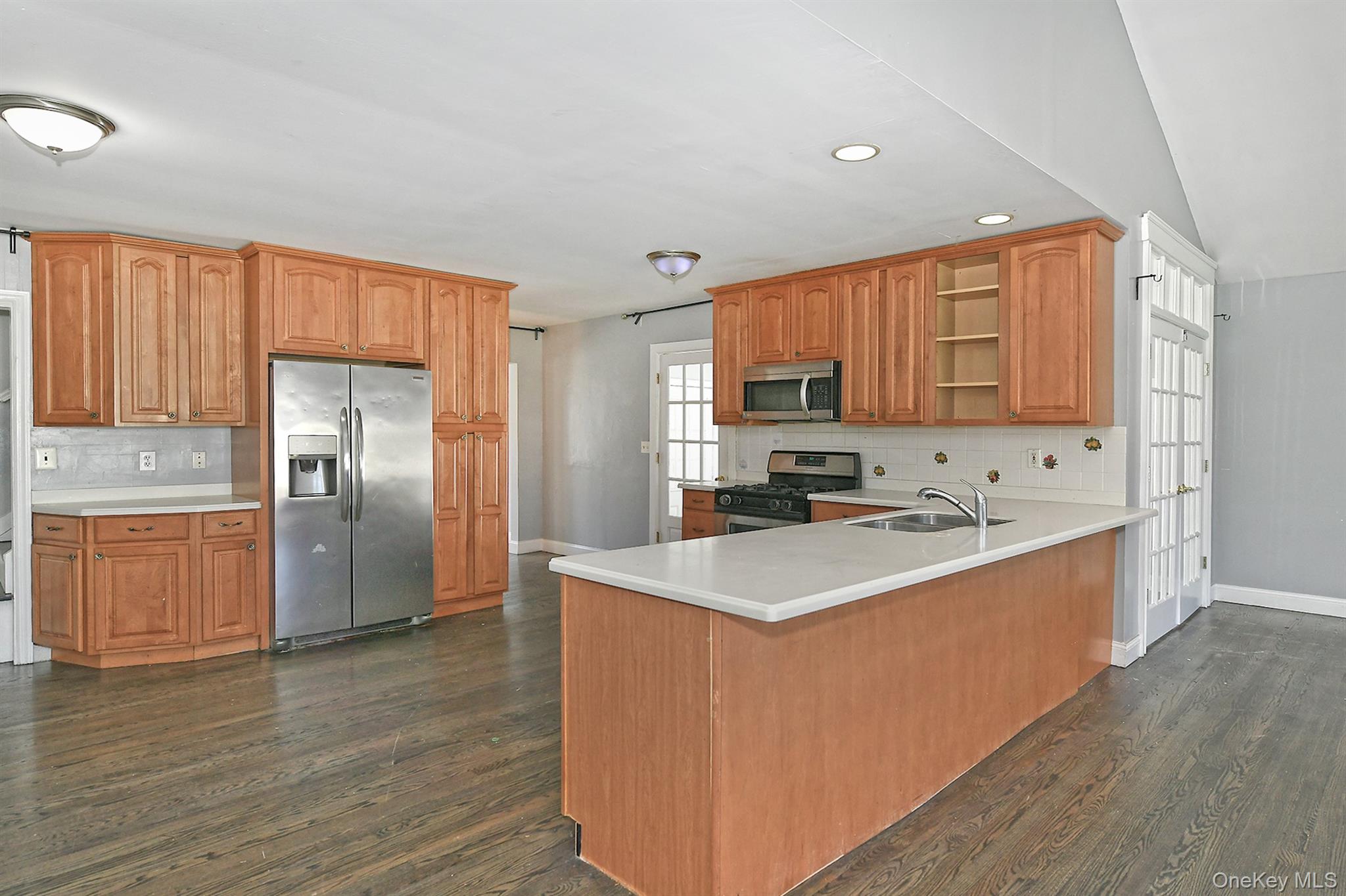 86 Horton Place Syosset, NY 11791 - Photo 9 of 22 a kitchen with stainless steel appliances granite countertop a sink stove refrigerator and cabinets