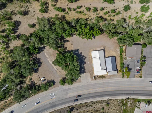 an aerial view of a house with a yard and sitting area