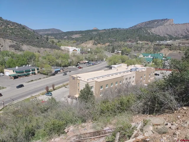a view of a road with a mountain in the background