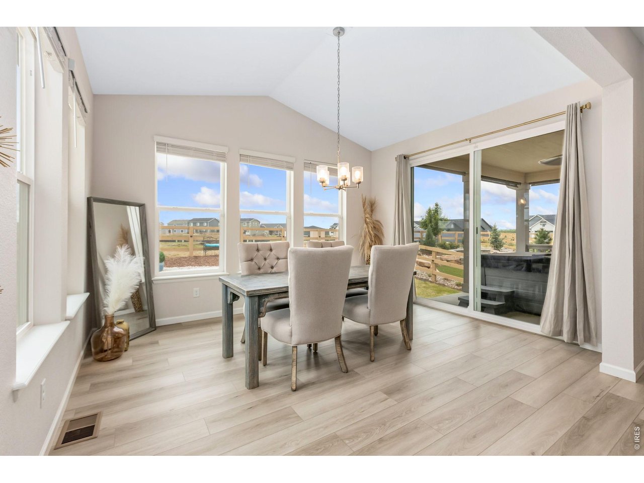 955 Rustling Street Windsor, CO 80550 - Photo 8 of 34 a view of a dining room with furniture window and wooden floor