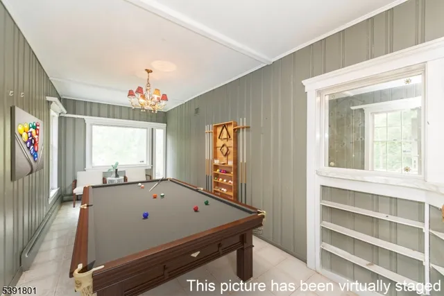 a room with pool table and windows