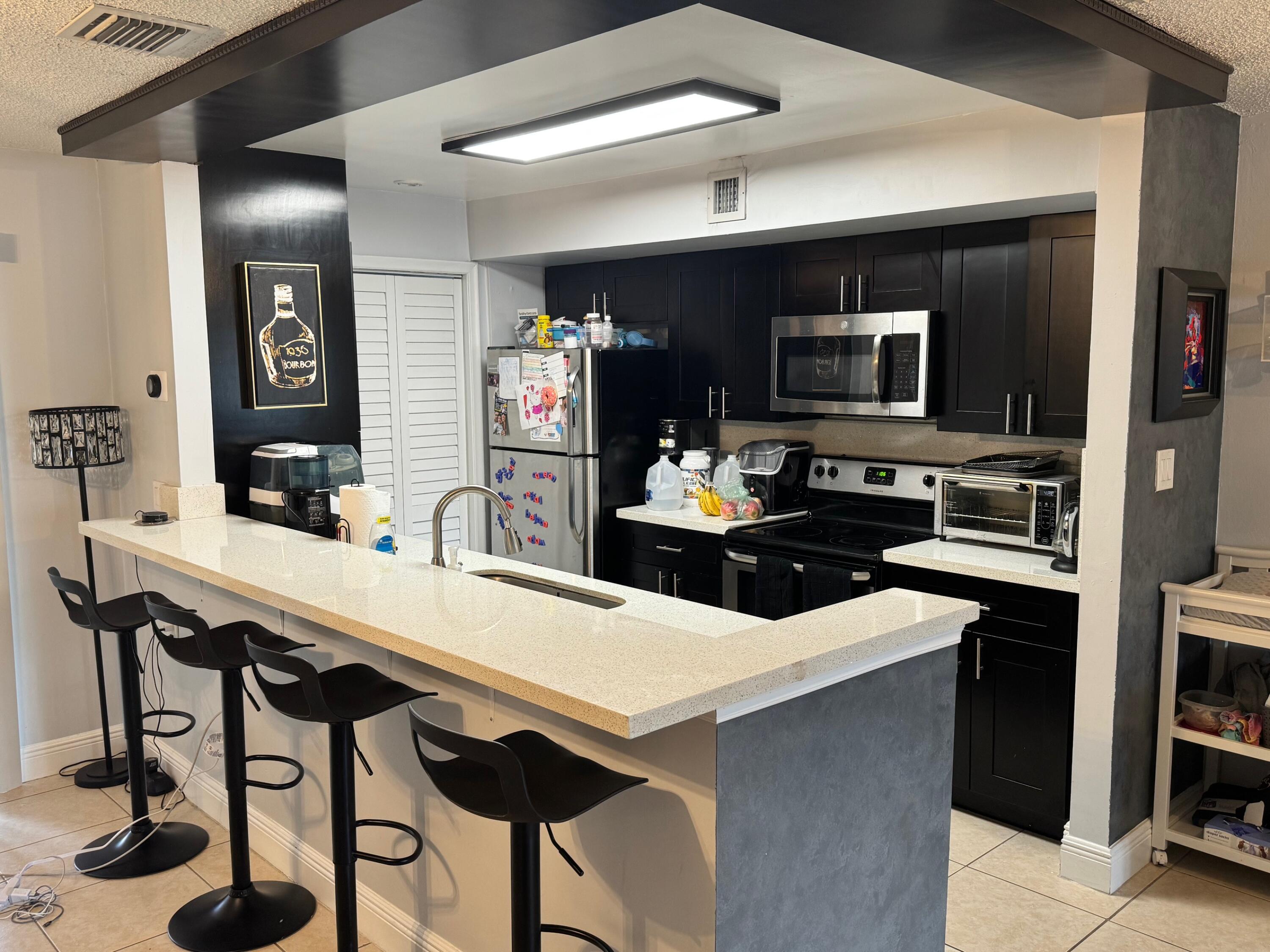 4952 Sheridan Street, Unit 2 Hollywood, FL 33021 - Photo 1 of 8 a kitchen with a table and chairs in it