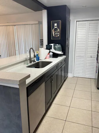 a kitchen with a sink and a refrigerator