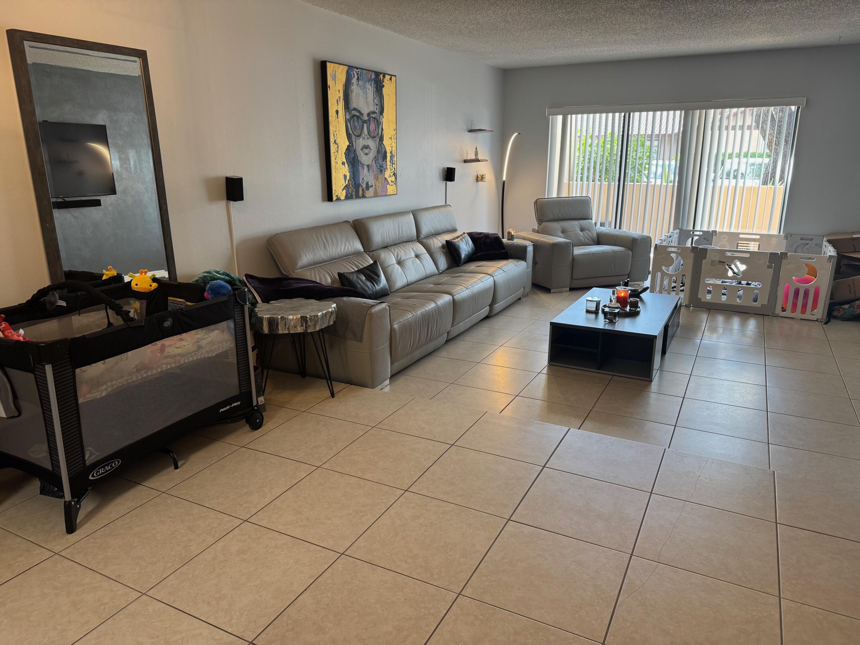 4952 Sheridan Street, Unit 2 Hollywood, FL 33021 - Photo 4 of 8 a living room with furniture and a window