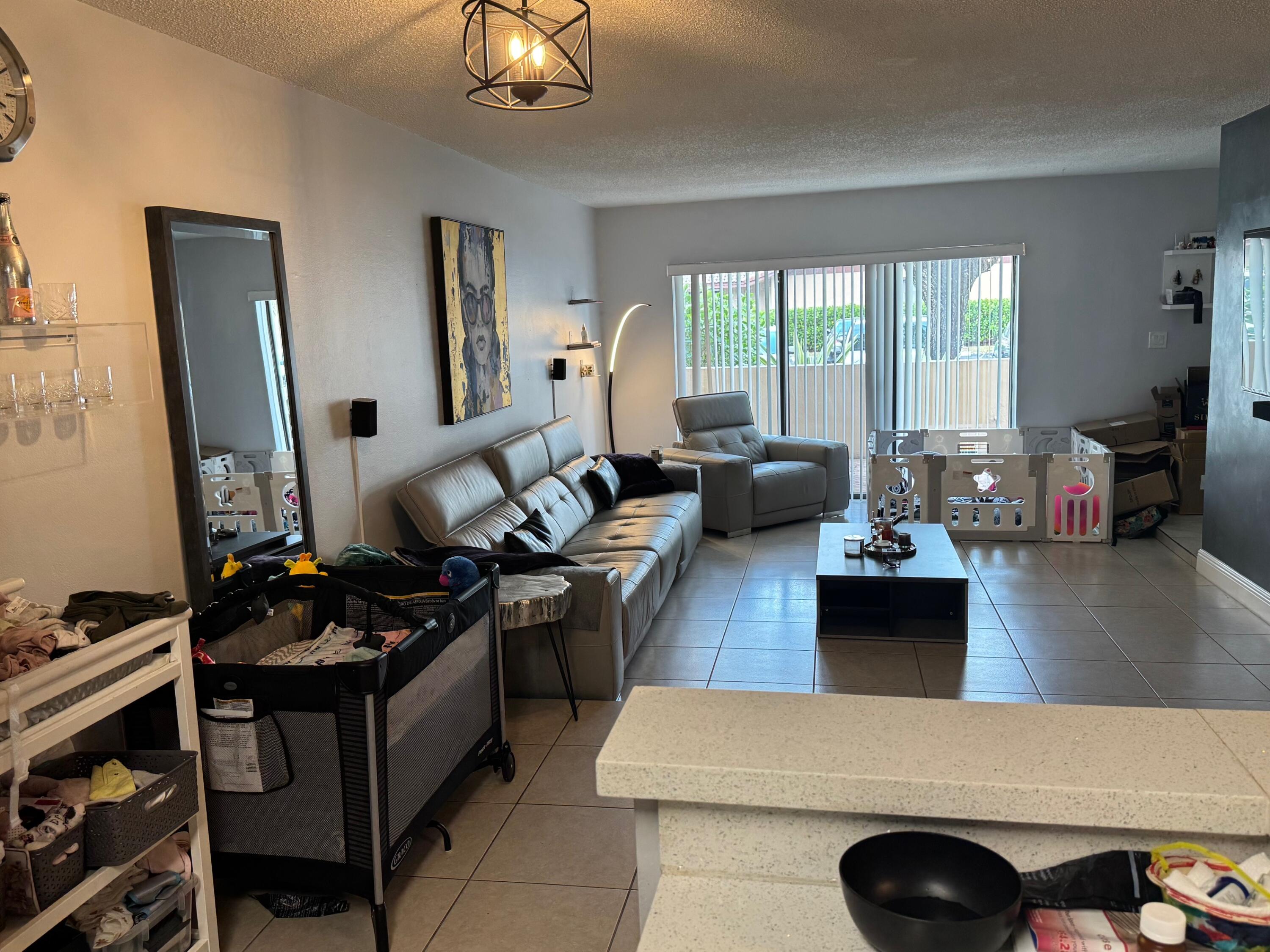 4952 Sheridan Street, Unit 2 Hollywood, FL 33021 - Photo 6 of 8 a living room with furniture window and wooden floor