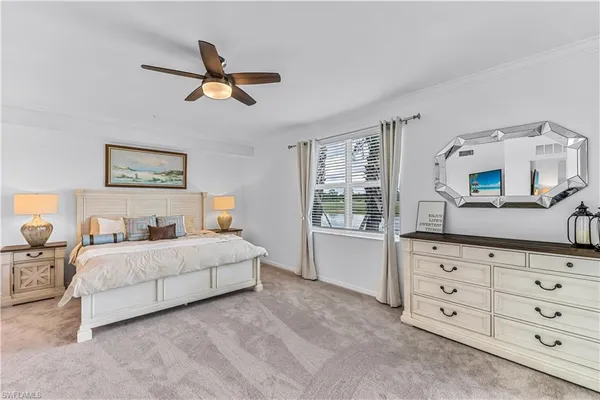 a bedroom with a large bed and a dresser