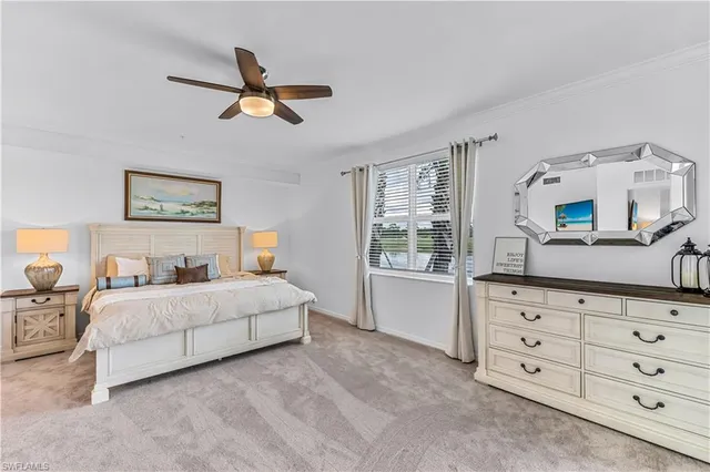 a bedroom with a large bed and a dresser