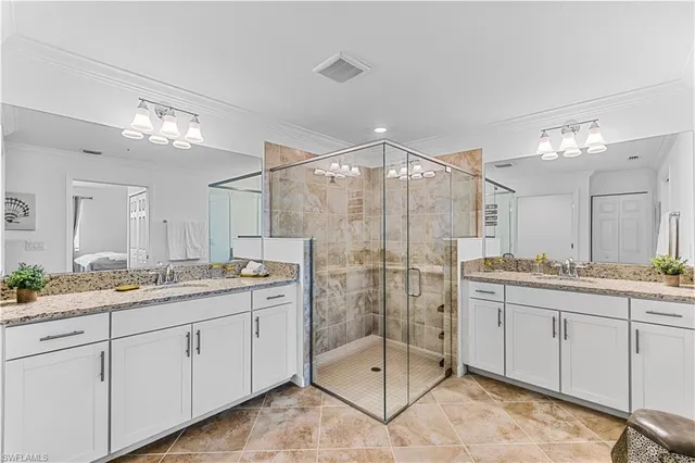 a bathroom with a granite countertop sink a toilet a large mirror and shower