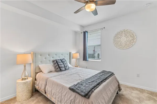 a bedroom with a bed and lamp