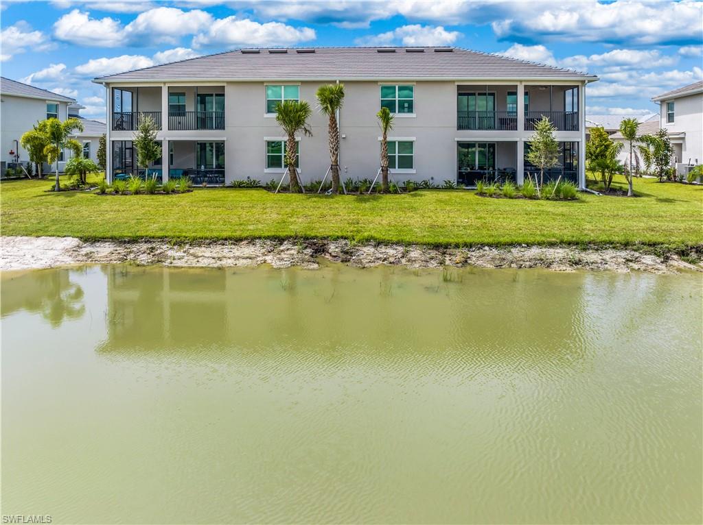 15943 Grassland Lane, Unit 3912 Babcock Ranch, FL 33982 - Photo 20 of 20 a front view of a house with a garden and lake view