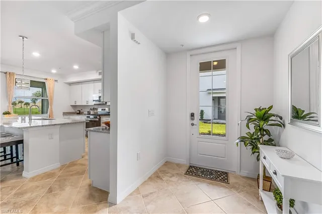 a living room with a potted plant and couches