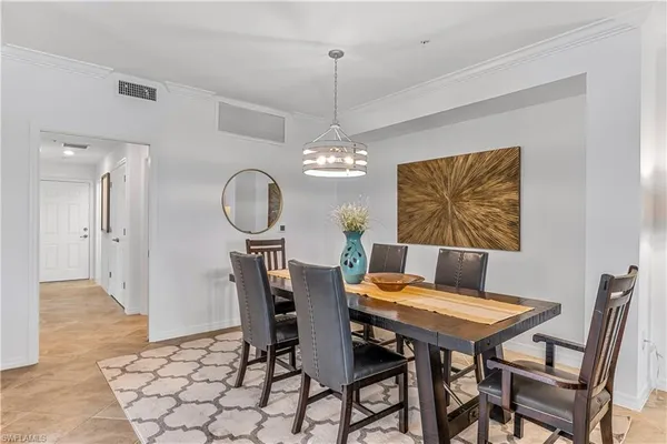 a view of a dining room with furniture and chandelier