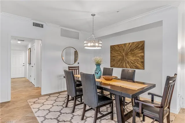 a view of a dining room with furniture and chandelier
