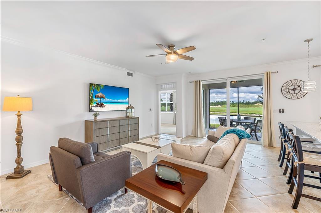 15943 Grassland Lane, Unit 3912 Babcock Ranch, FL 33982 - Photo 6 of 20 a living room with furniture a flat screen tv and a large window
