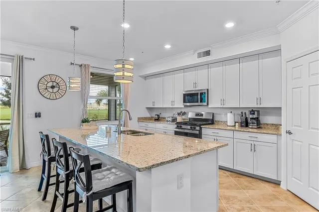 a kitchen with a table chairs stove top oven and cabinets