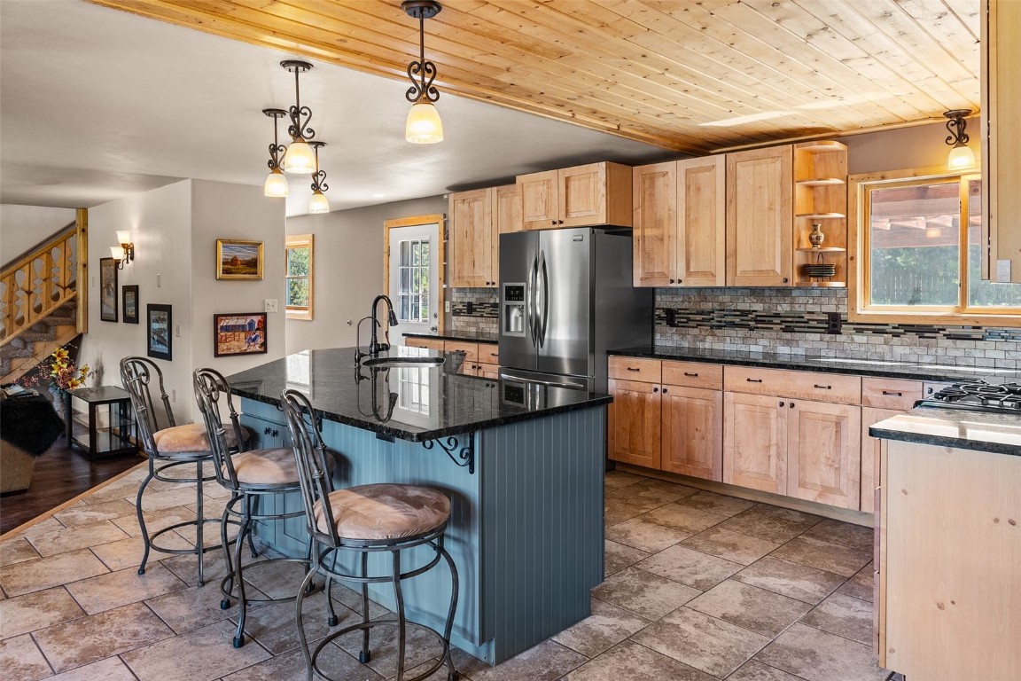 367 G Road Silverthorne, CO 80498 - Photo 4 of 50 a kitchen with stainless steel appliances granite countertop a table chairs refrigerator and sink