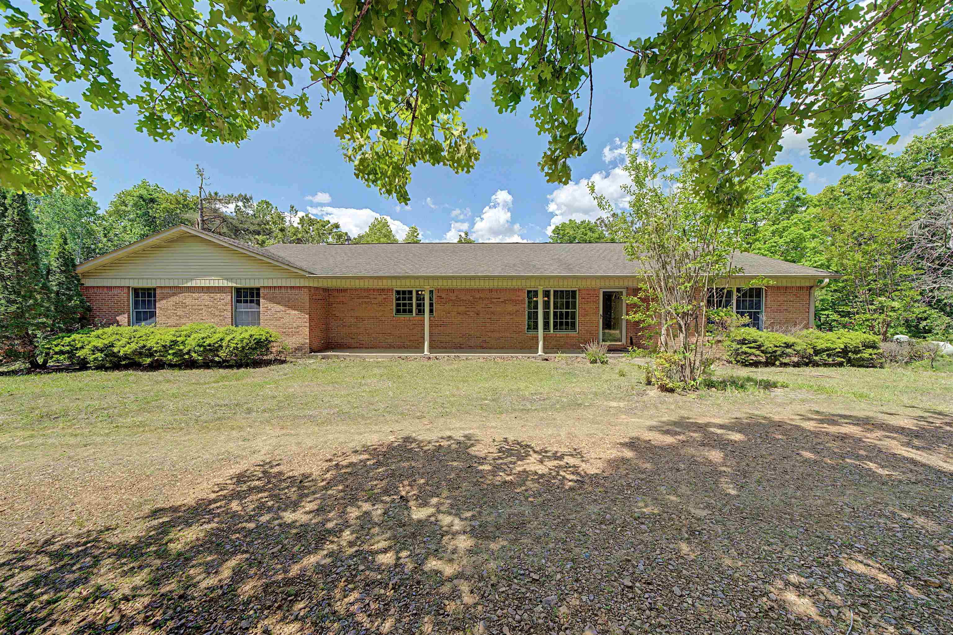 Brick exterior with a gabled roofline and covered entry