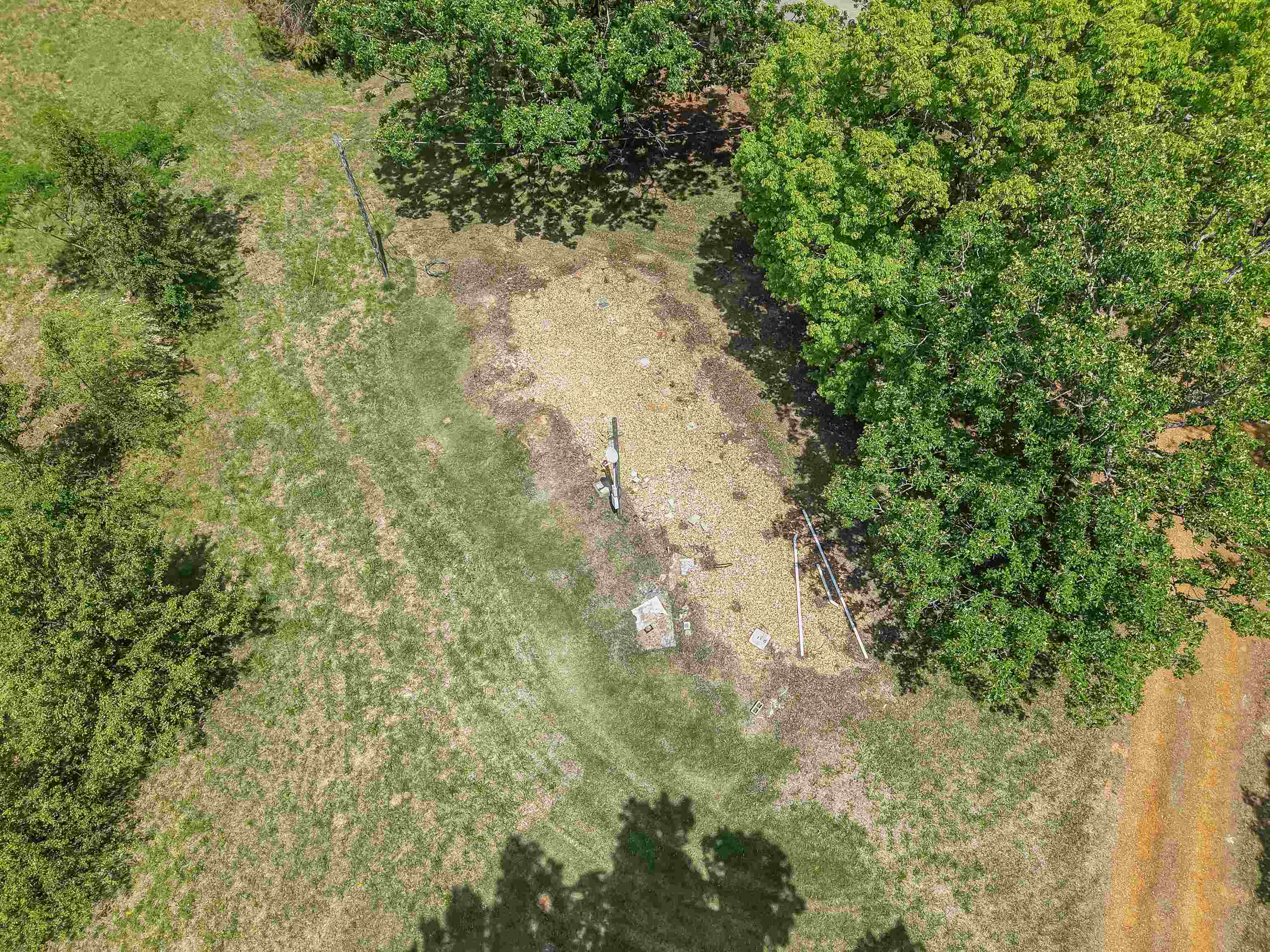 162 Lawton Road Selmer, TN 38375 - Photo 33 of 36 Expansive lot featuring a mix of mature trees and open grassy areas, with a dirt path bordering the property