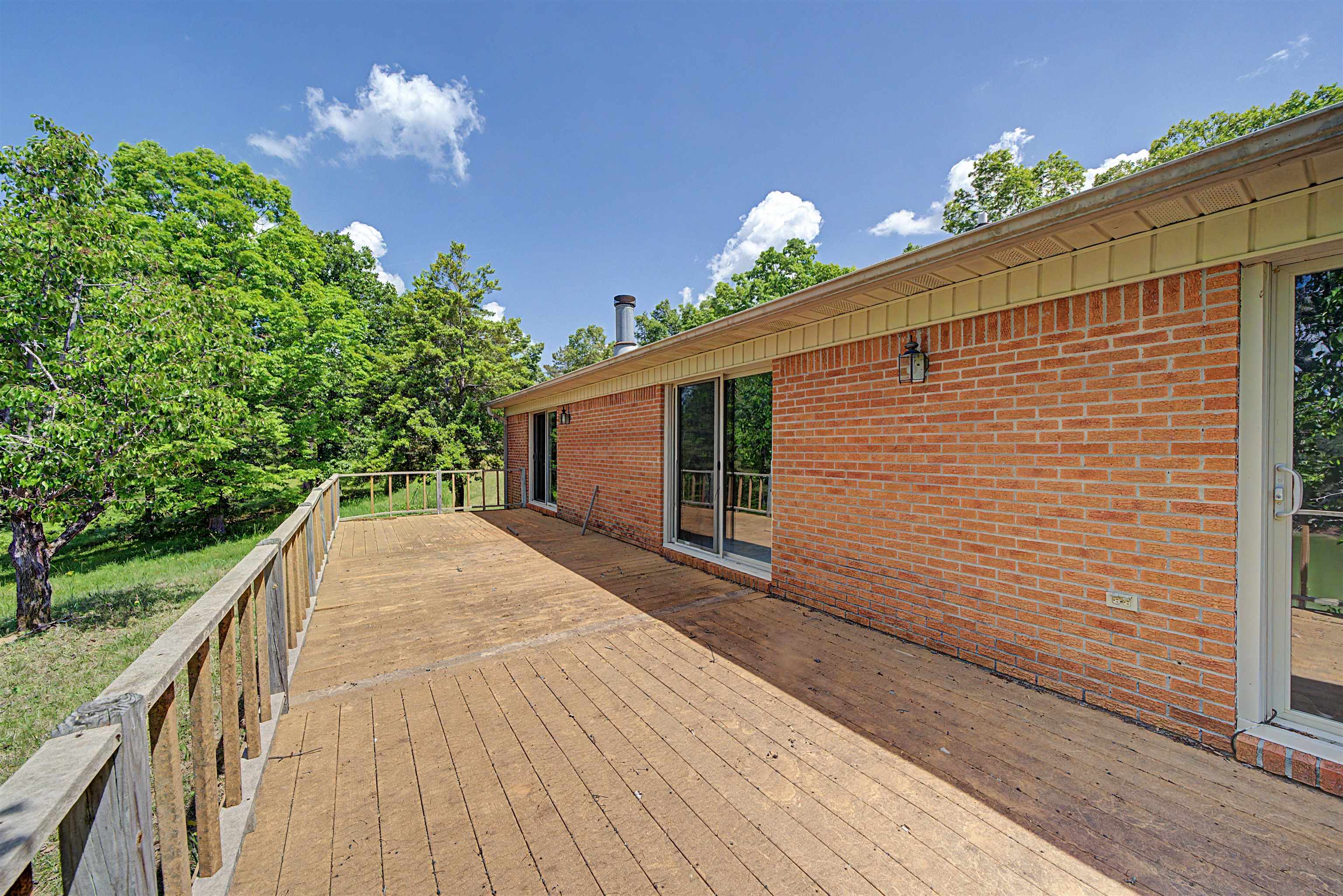 162 Lawton Road Selmer, TN 38375 - Photo 35 of 36 Spacious wood deck with a natural finish, featuring a wood railing
