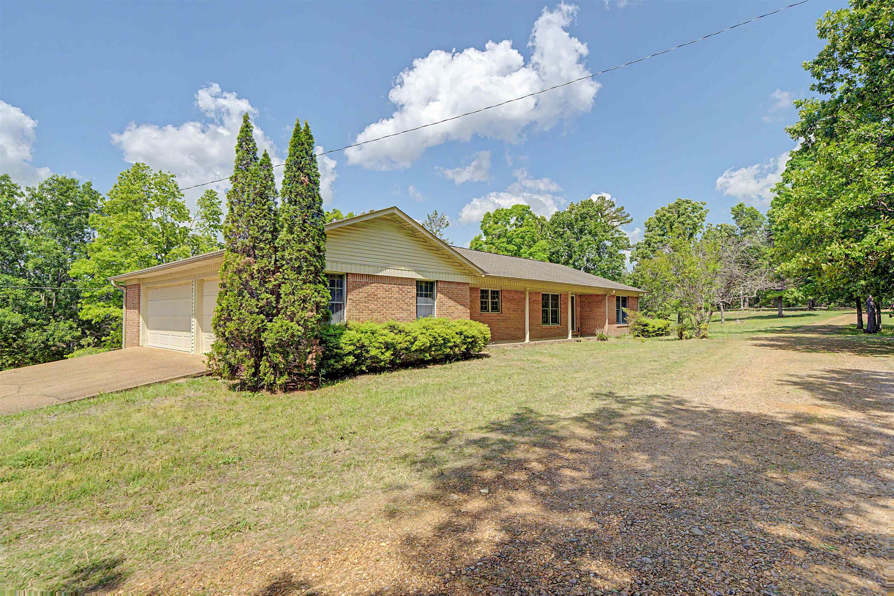 162 Lawton Road Selmer, TN 38375 - Photo 6 of 36 Brick exterior featuring a covered front porch and an attached two-car garage