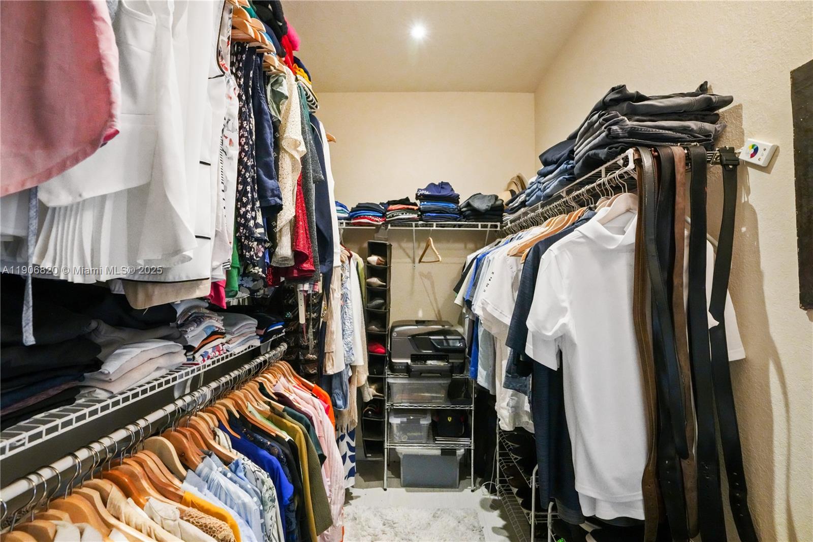 9127 Southwest 171st Court Miami, FL 33196 - Photo 11 of 54 a view of walk in closet with clothes and shoes