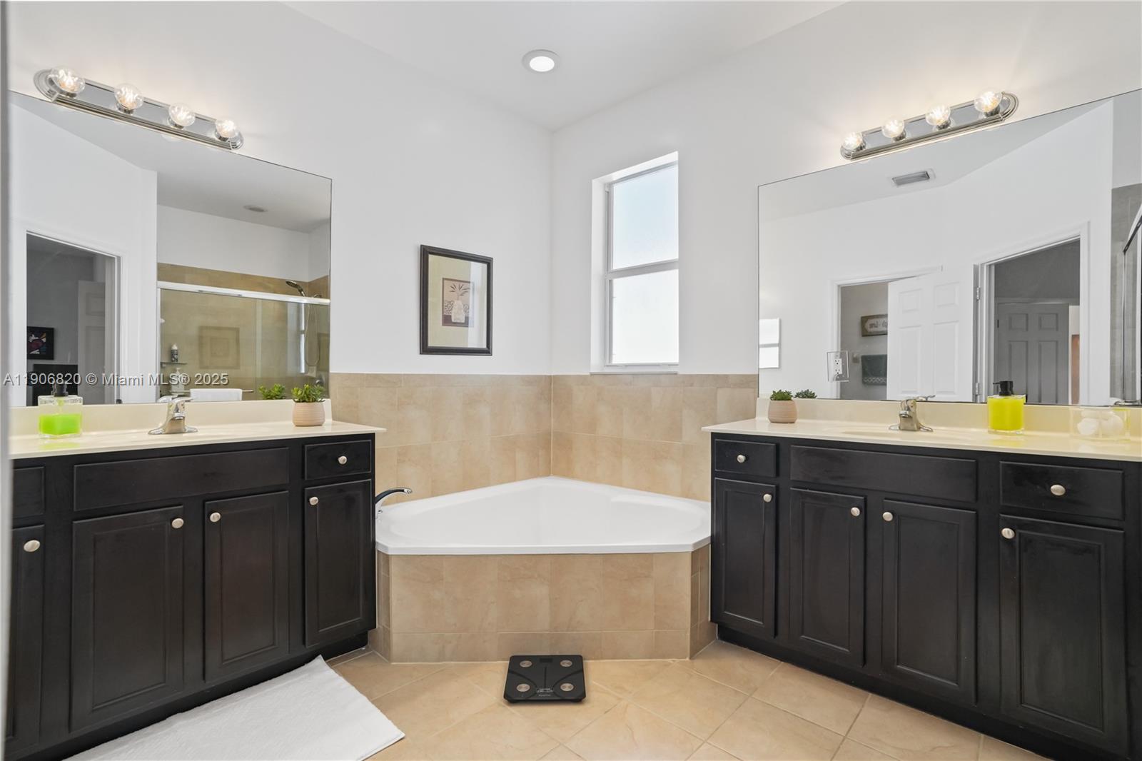 9127 Southwest 171st Court Miami, FL 33196 - Photo 18 of 54 a bathroom with a sink and a mirror