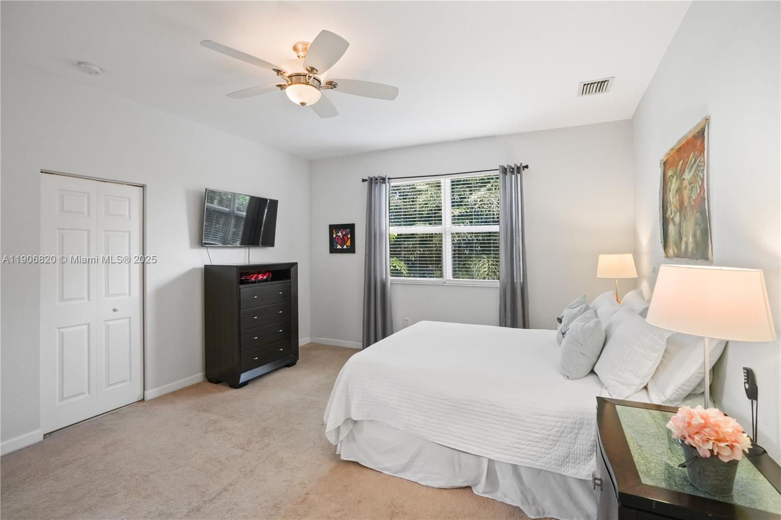 9127 Southwest 171st Court Miami, FL 33196 - Photo 23 of 54 a bedroom with a bed and a chandelier