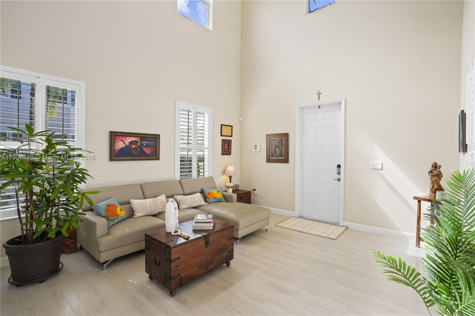 9127 Southwest 171st Court Miami, FL 33196 - Photo 27 of 54 a living room with furniture and a potted plant