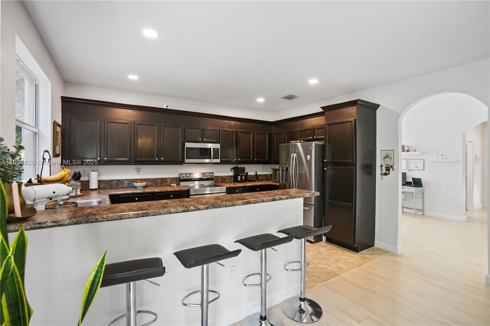 9127 Southwest 171st Court Miami, FL 33196 - Photo 29 of 54 a kitchen with stainless steel appliances a refrigerator and a stove top oven
