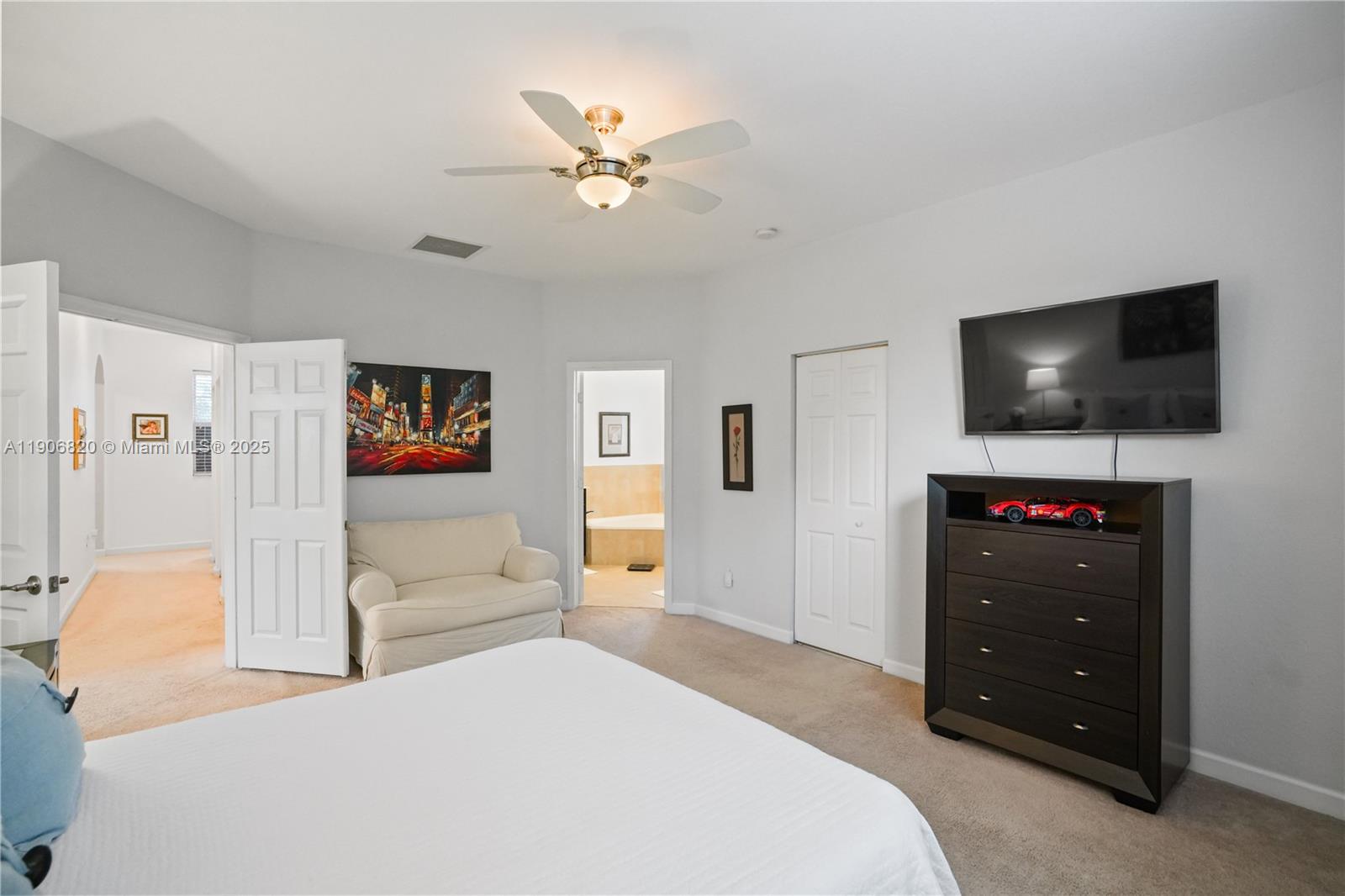 9127 Southwest 171st Court Miami, FL 33196 - Photo 30 of 54 a bedroom with a bed and a flat screen tv