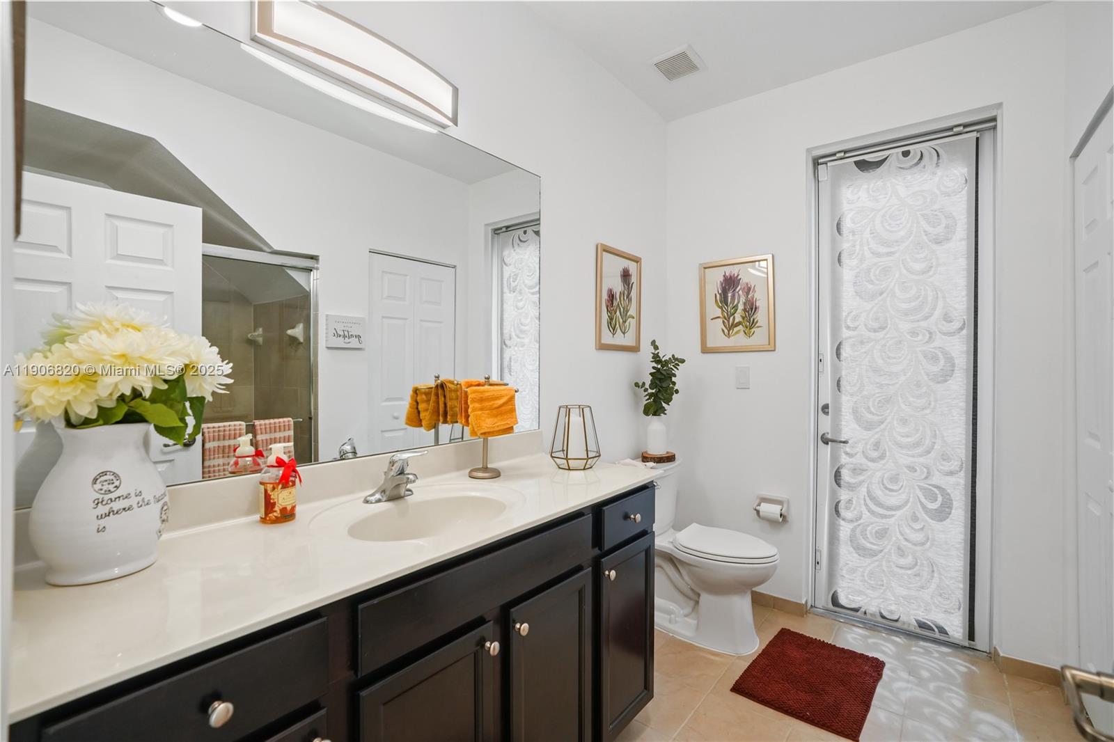 9127 Southwest 171st Court Miami, FL 33196 - Photo 39 of 54 a bathroom with a sink vanity mirror and toilet