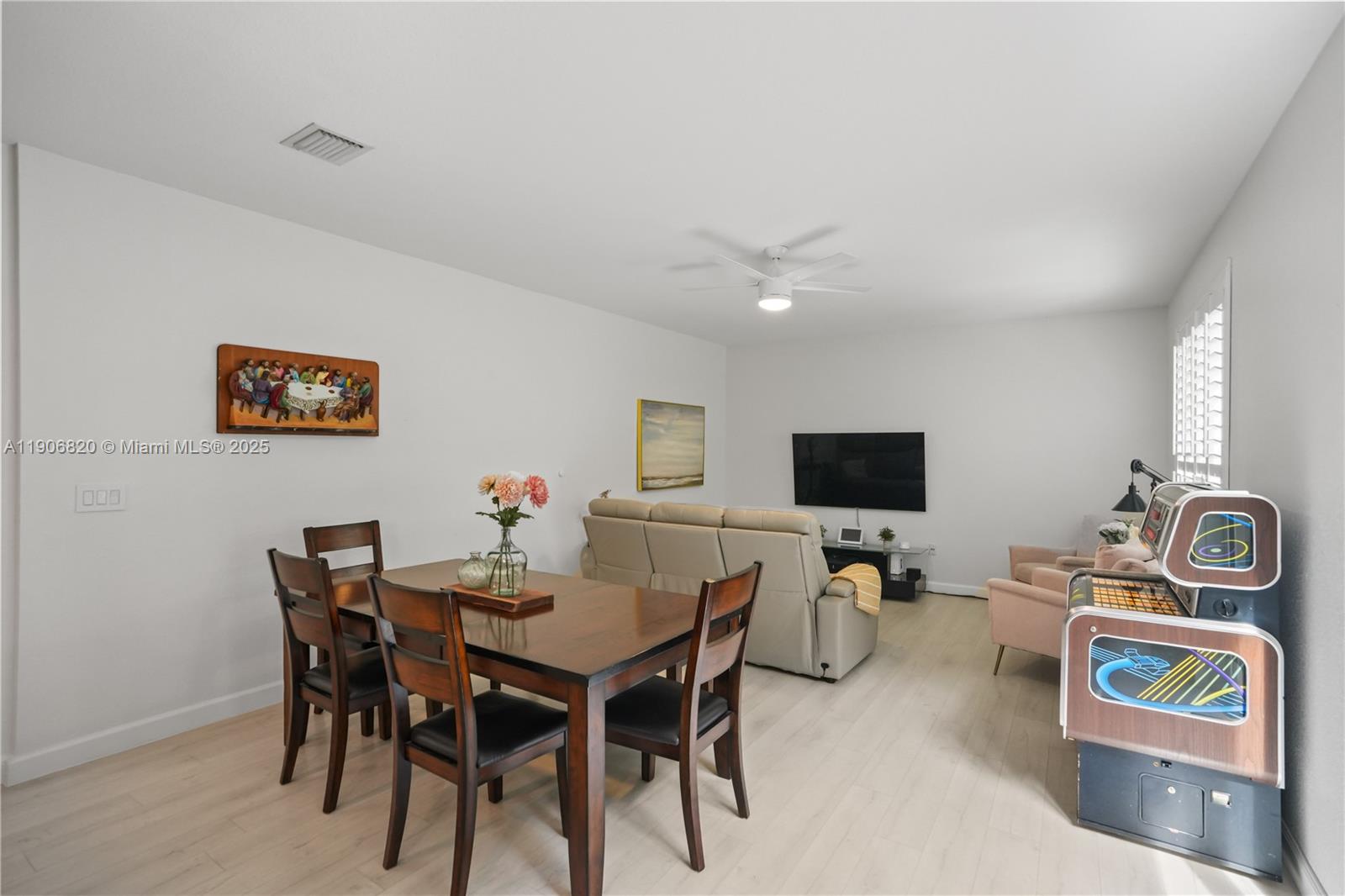 9127 Southwest 171st Court Miami, FL 33196 - Photo 43 of 54 a view of a dining room with furniture and a flat screen tv
