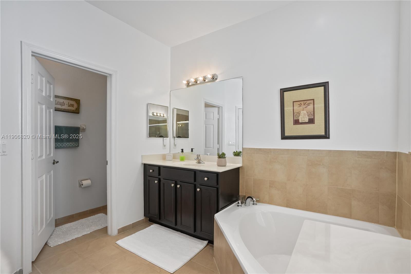 9127 Southwest 171st Court Miami, FL 33196 - Photo 5 of 54 a bathroom with a tub a sink and mirror