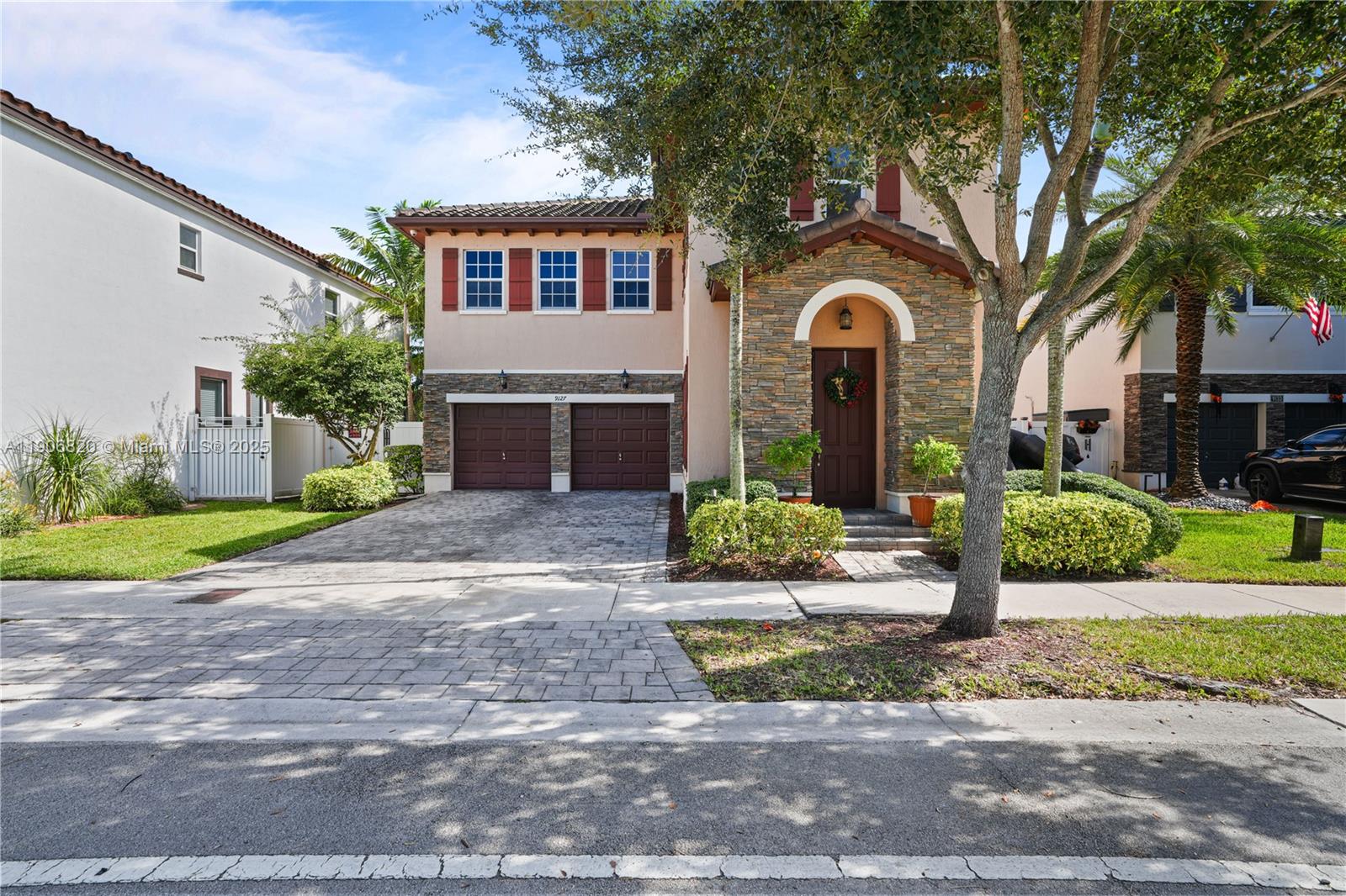 9127 Southwest 171st Court Miami, FL 33196 - Photo 51 of 54 a front view of a house with a yard and potted plants